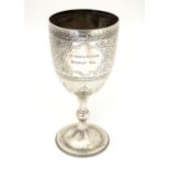 A silver trophy cup of goblet form hallmarked Sheffield 1902 maker Walker & H and engraved ' The
