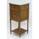 A late 19thC French bedside table with a marble top above a single short drawer and panelled