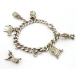 A silver charm bracelet set with white metal charms Please Note - we do not make reference to the