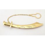 A gold tie clip formed as a scimitar / sword marked 750. 2 1/4" long Please Note - we do not make