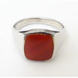 A Gentleman's silver signet ring set with carnelian coloured detail to top. Ring size approx S