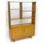 A Vintage / Retro teak room divider / cabinet with five shelves above two cupboards with shaped