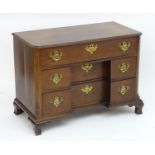 An unusual antique mahogany block front desk with a moulded top with canted corners above three long