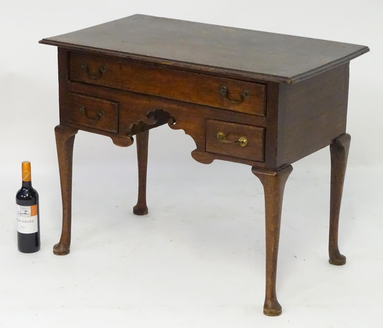 A mid 18thc oak lowboy with a moulded rectangular top above a single long and two short drawers with - Image 3 of 5