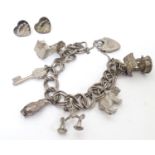 A silver and white metal charm bracelet with various silver and silver plate charms, together with a