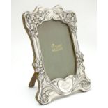 An Art Nouveau silver photograph frame with floral detail. Hallmarked Birmingham 1902. the whole