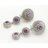 A pair of drop earrings set with amethysts ( unmarked tests as silver) Approx 2" long Please