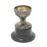 A small silver trophy cup with crossed golf club decoration, titled 'Souvenir Dunlop Golf Ball