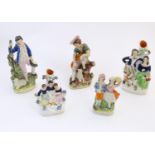 Five assorted Staffordshire pottery figures comprising two models of shepherds and their sheep,