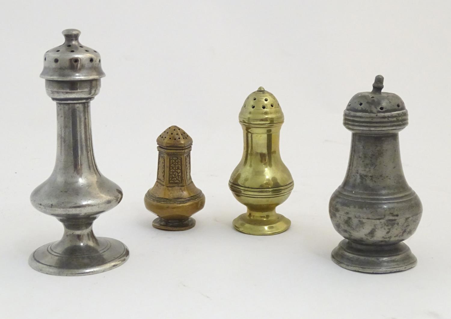 Four assorted 18thC casters to include brass and pewter examples etc. The largest approx 5 1/4" high