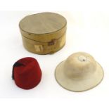 A 20thC Christy's London pith helmet for the Tropics, labelled within. Together with a fez, both