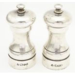 Two silver salt / pepper mills / grinders hallmarked London 1987, maker Christopher Milton