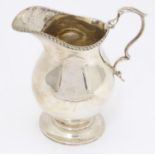 A silver cream jug hallmarked Birmingham 1921 maker S W Smith & Co. Approx.4 1/2" high Please Note -