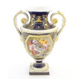 A Bloor Derby twin handled urn vase with central floral detail and scrolling gilt decoration. Marked