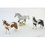 Three Beswick horses comprising Galloping Horse, model no. 1374, a Piebald Pinto Pony and a Skewbald