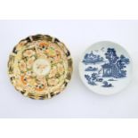 A Royal Worcester blue and white saucer with Oriental landscape detail. Marked with crescent moon