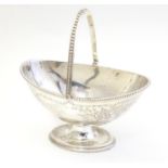 A silver plate bonbon dish of basket form. 6 3/4" wide Please Note - we do not make reference to the