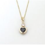 A 9ct gold pendant of heart form set with sapphire and white stone on 9ct chain. Approx. 17" long