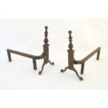 A pair of 19thC fire dogs / andirons, of brass and wrought iron construction, with ball and claw