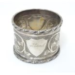 A white metal napkin ring with engraved decoration, probably Indian, indistinctly marked. Please