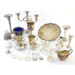 A quaintly of assorted silver plated wares to include candelabra, cream jugs, cigarette box,