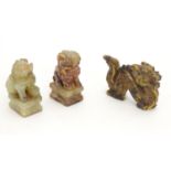 An Oriental carved tiger's eye model of a dragon. Together with two hardstone models of stylised foo