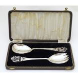 A cased pair of silver servers with fretwork detail to handles hallmarked Birmingham 1942 maker