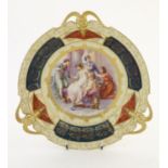 A Continental three handled cabinet plate, the central scene depicting Cupid and Psyche with