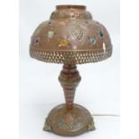 A late 19thC /early 20thC Ottoman style copper table lamp and shade, decorated with pierced