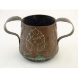 An Arts and Crafts twin handled copper jardiniere with foliate detail. Approx. 9 1/2" high Please