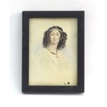A 19thC watercolour portrait miniature depicting a young woman with black curly hair wearing a pearl