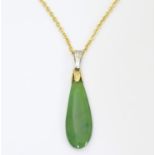 A gilt metal necklace set with jade / nephrite pendant. Approx. 19" long Please Note - we do not