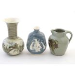Three studio pottery items comprising a small jug by Caroline Eeles with floral and foliate
