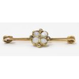 A yellow metal bar brooch set with opals and diamonds. Approx. 1 1/4" wide Please Note - we do not