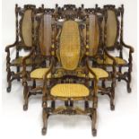 A set of six Carolean style side oak chairs with shaped carved top rails flanked by turned finials