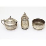 A three piece silver cruet set comprising salt, pepperette and mustard pot hallmarked Birmingham