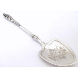 A silver preserve spoon with engraved bowl and apostle finial to handle, hallmarked Sheffield