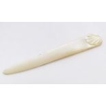 An early 20thC mother of pearl letter opener with shell detail. Approx. 4 1/4" Please Note - we do