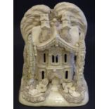 A large Victorian Staffordshire creamware pastille burner modelled as a house and garden with trees.