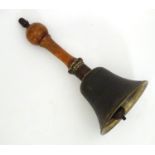A 20thC hand bell with a turned wooden handle and acorn finial. Approx. 10 1/4" Please Note - we