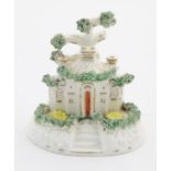 A Staffordshire pottery model of a cottage. Approx. 4 1/4" high Please Note - we do not make