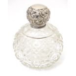 A cut glass scent / perfume bottle of spherical form with silver top, hallmarked Birmingham 1910,