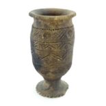 Ethnographic / Native / Tribal : An African pottery pedestal vase with incised detail and circular