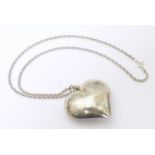 A white metal pendant and chain, the pendant formed as a heart. Approx. 20" long overall Please Note