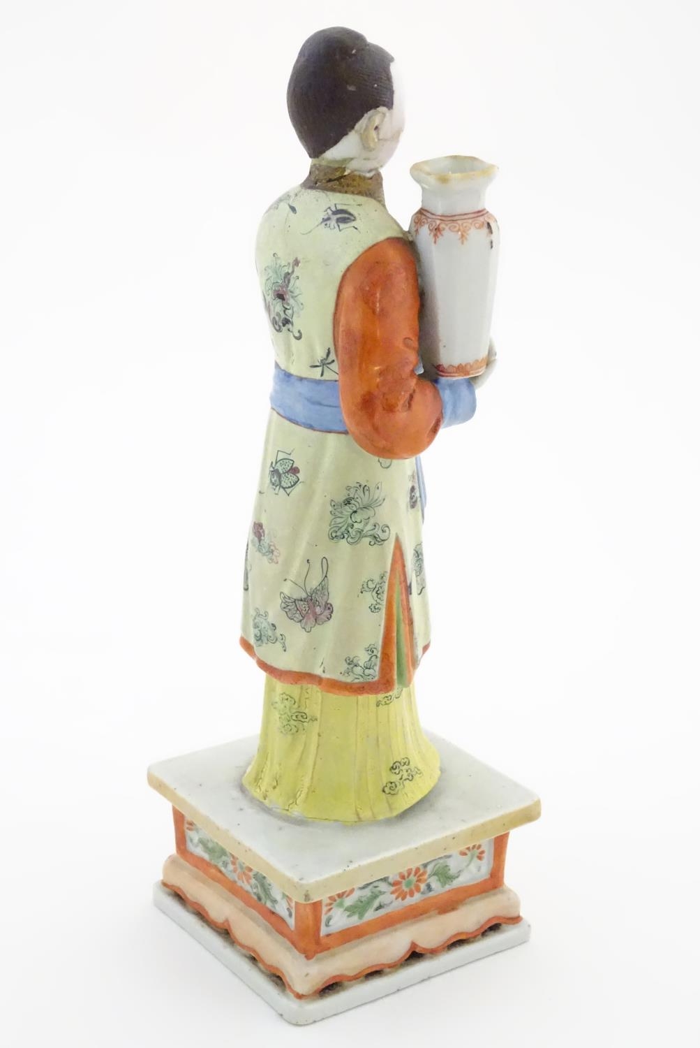 An Oriental porcelain model of a male figure wearing a kimono with butterfly and floral detail - Image 6 of 8