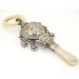 A silver rattle with mother of pearl teeth, hallmarked Birmingham 1919, maker Adie Lovekin Ltd.