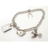 A silver charm bracelet set with various silver and silver plate charms. Please Note - we do not
