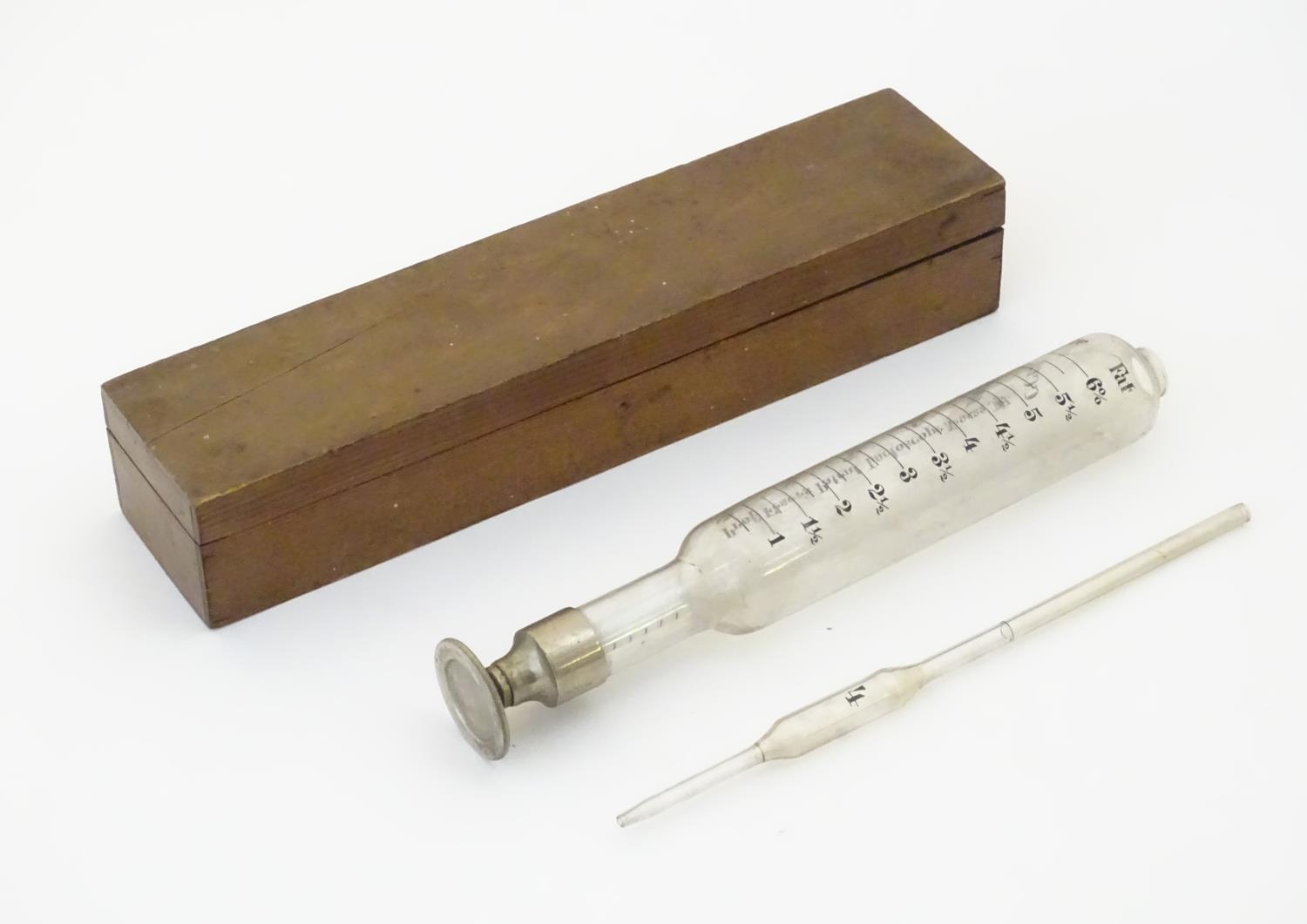 A 20thC cased glass Lactoscope with metal base, the interior with label: 'Professor Feser's Patent