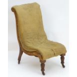 A Victorian slipper chair for re upholstery, standing on turned tapering front legs and sabre back