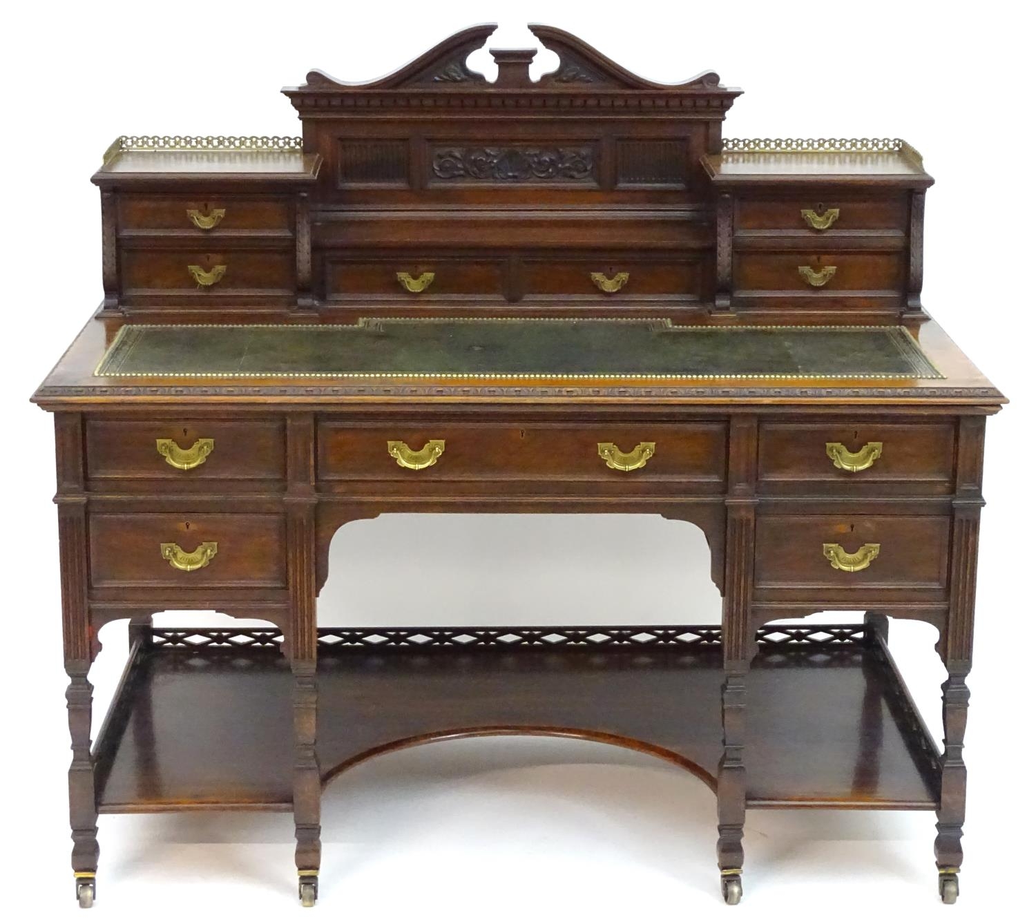 A late 19thC / early 20thC walnut Shoolbred desk with a carved back stand and a pierced brass - Image 5 of 13